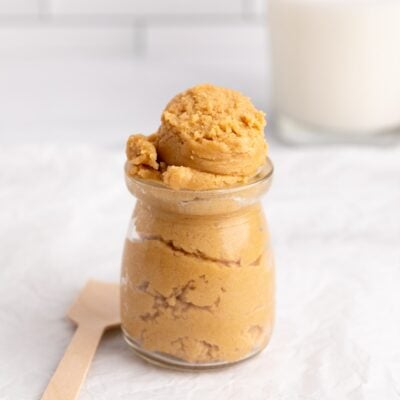 edible peanut butter cookie dough in glass container.