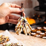 holding pretzel broomstick.