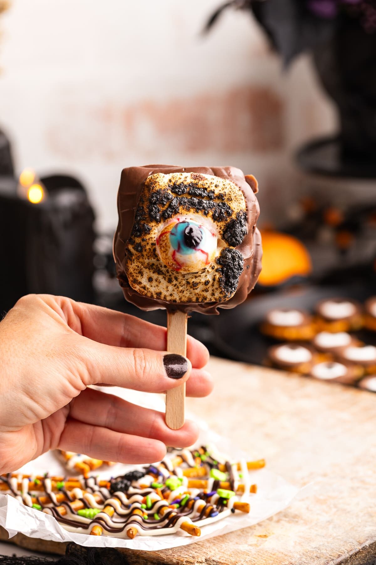 holding Halloween S'mores Popsicle.