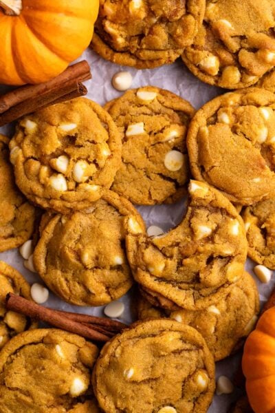 pumpkin white chocolate chip cookies on parchment.