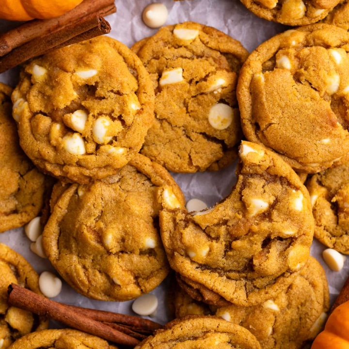 pumpkin white chocolate chip cookies on parchment.