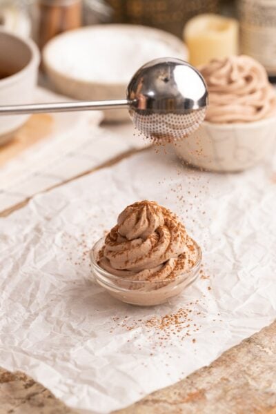sprinkling cocoa powder on top of chocolate whipped cream.