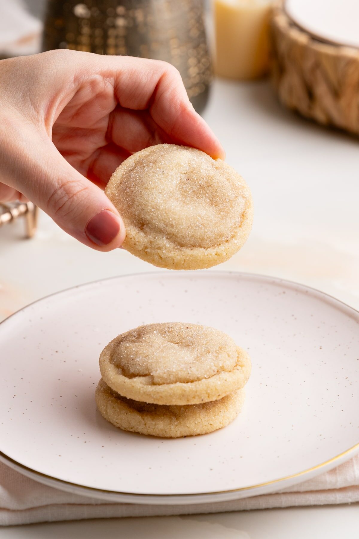 holding a brown butter sugar cookie.