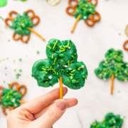 holding up shamrock pretzel treat.