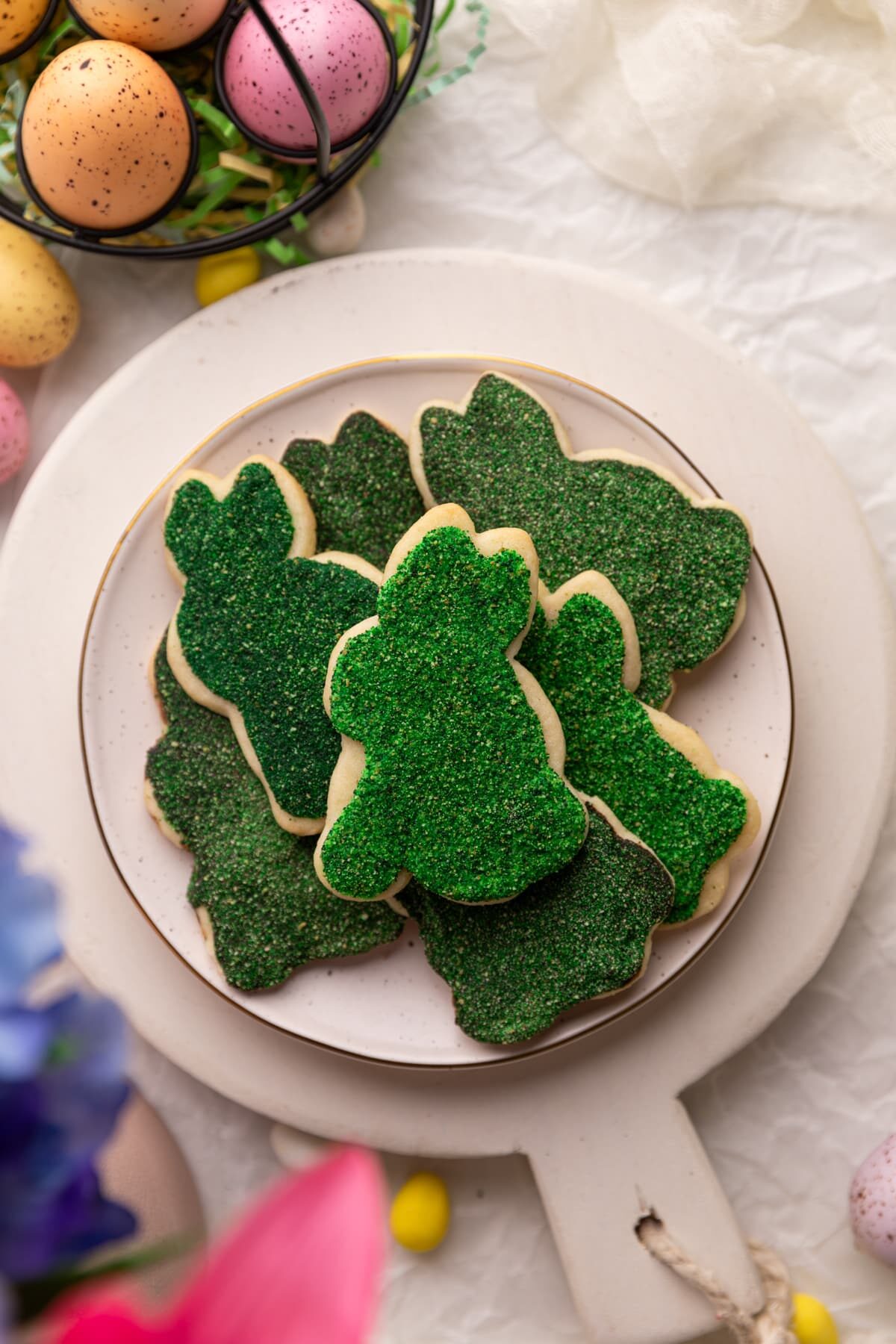 sugar cookies decorated with edible moss on serving plate.