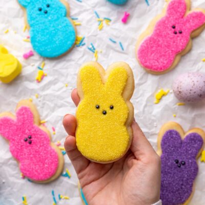 holding a peeps decorated sugar cookie.