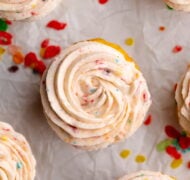 fruity pebbles cereal frosting piping on cupcake.