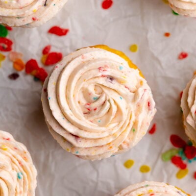 fruity pebbles cereal frosting piping on cupcake.