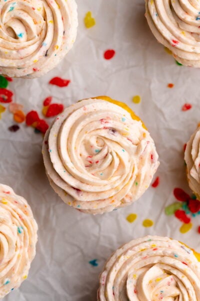 fruity pebbles cereal frosting piping on cupcake.