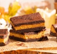 brownies stacked on parchment.