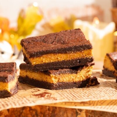 brownies stacked on parchment.