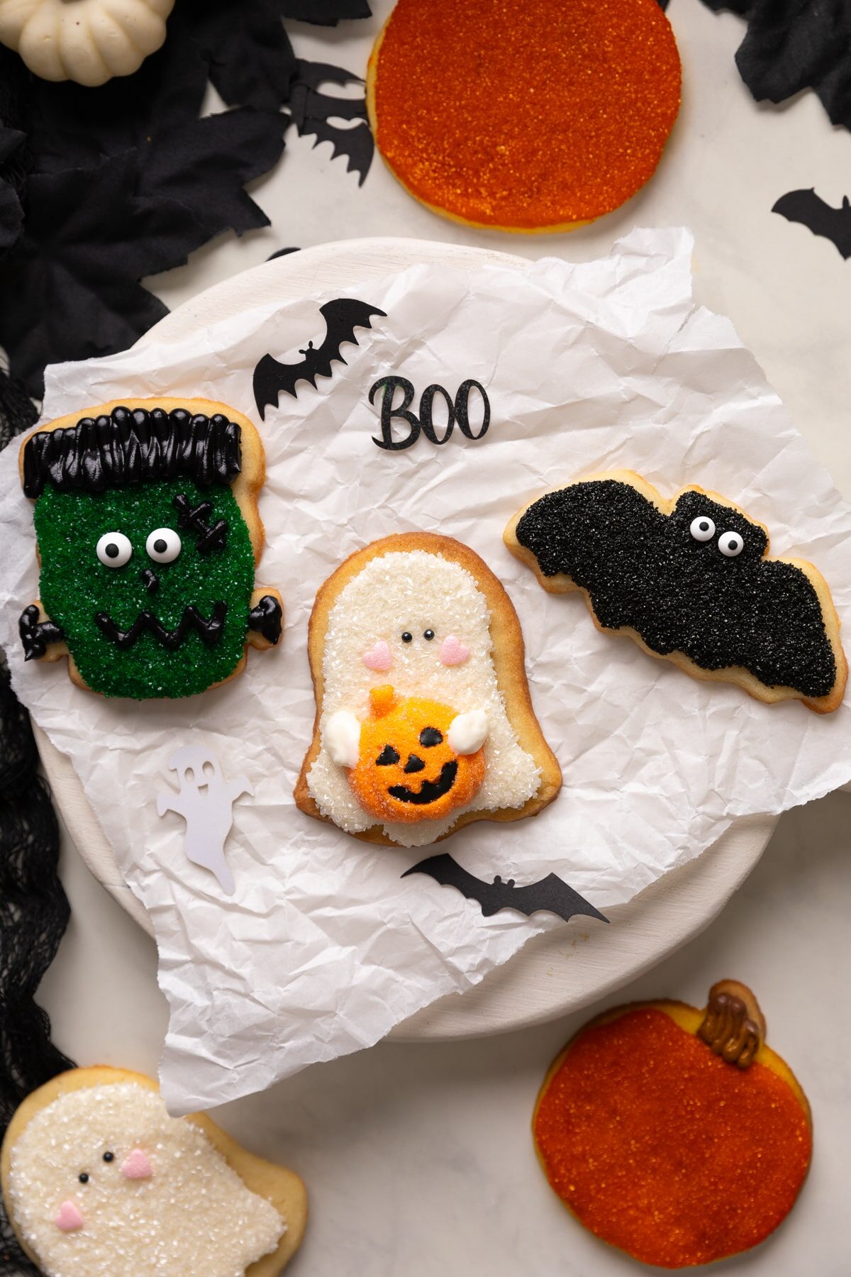 decorated halloween sugar cookies on parchment paper.