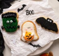 decorated halloween sugar cookies on parchment paper.