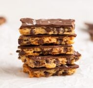 chocolate chip cookie brittle stacked on parchment.