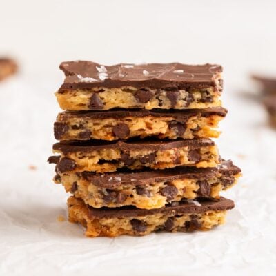 chocolate chip cookie brittle stacked on parchment.