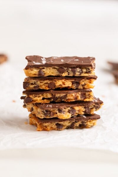 chocolate chip cookie brittle stacked on parchment.