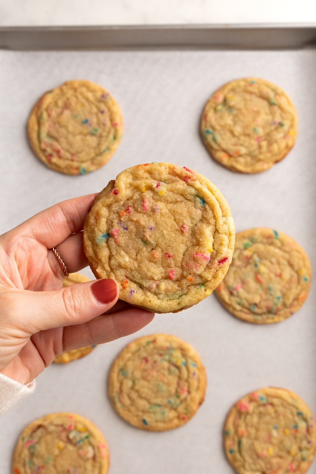 holding funfetti cookie.