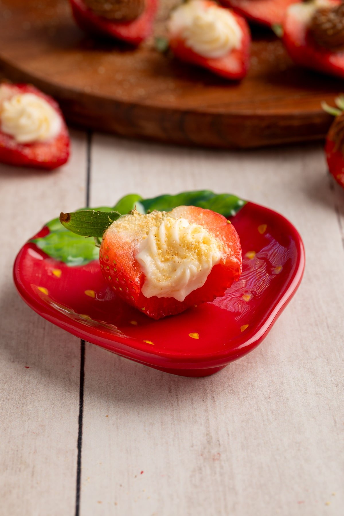 deviled strawberry on plate with bite taken out.