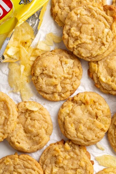 potato chip cookies and potato chips on parchment paper.