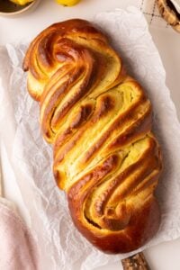 baked challah on cutting board.