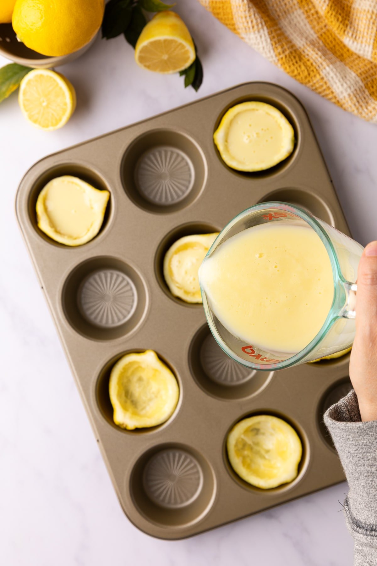 pouring lemon posset into serving containers.