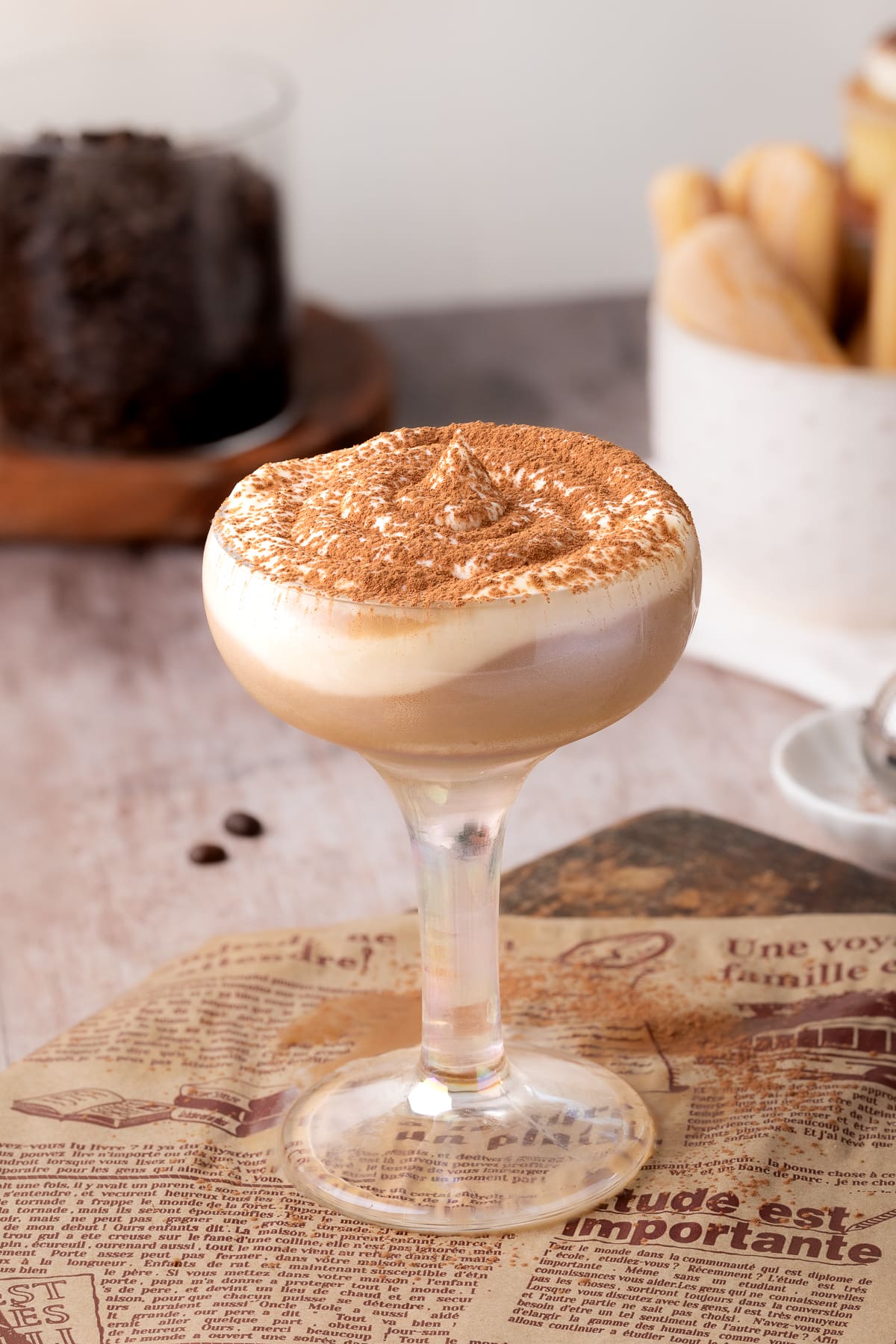 tiramisu cocktail with whipped crema and cocoa powder.