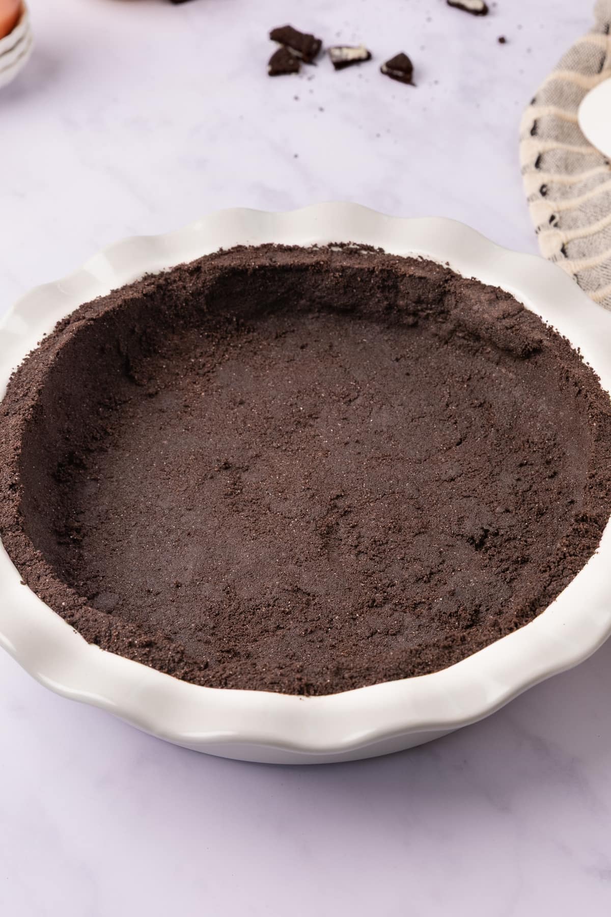 unfilled oreo pie crust in pan close up.