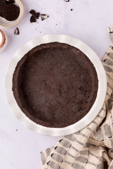 oreo pie crust in pie tin top view.