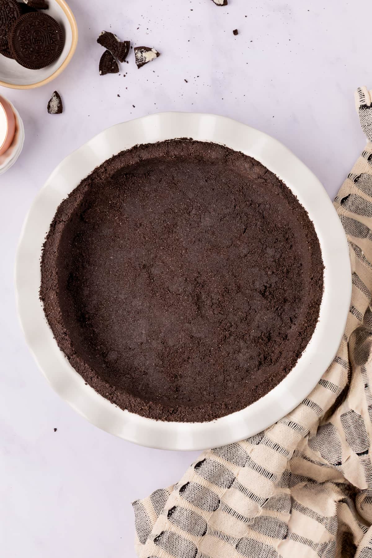 oreo pie crust in pie tin top view.