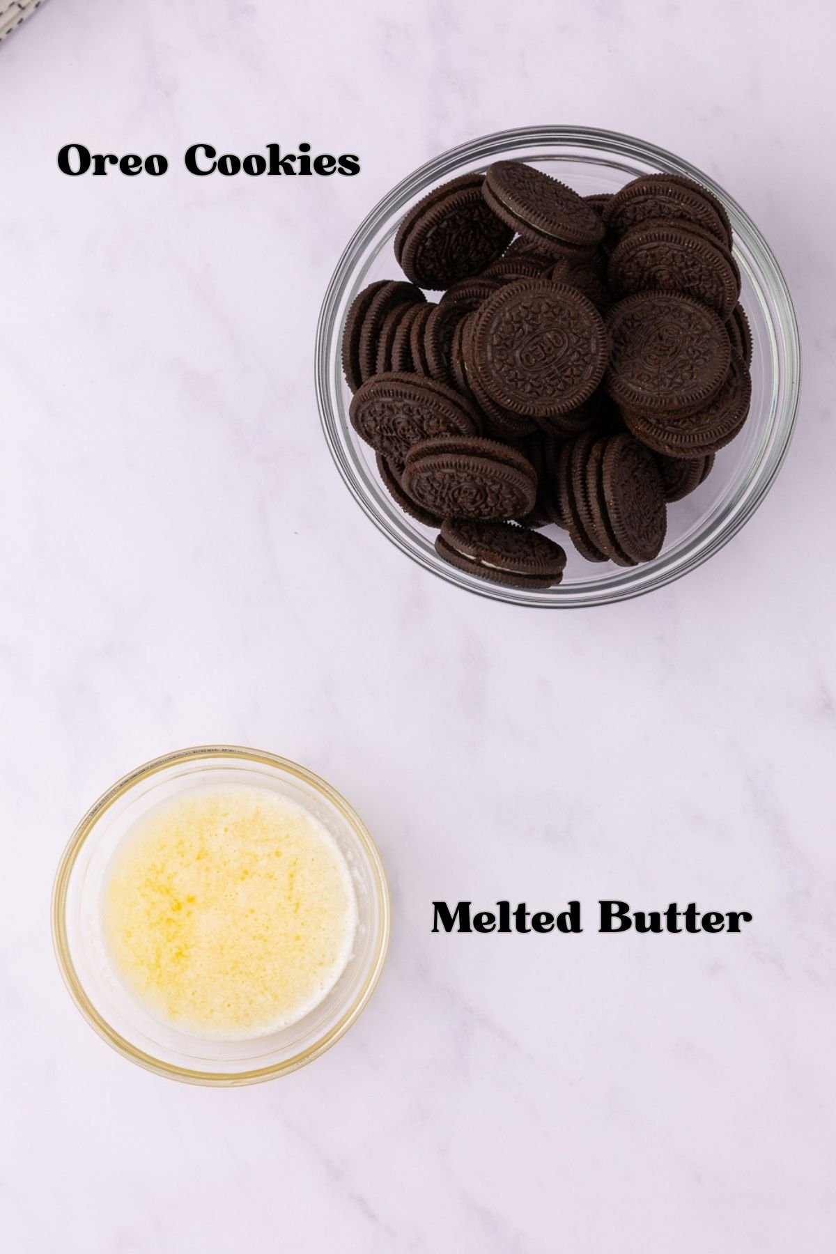 Oreo pie crust ingredients of Oreo cookies and melted butter in separate bowls. 