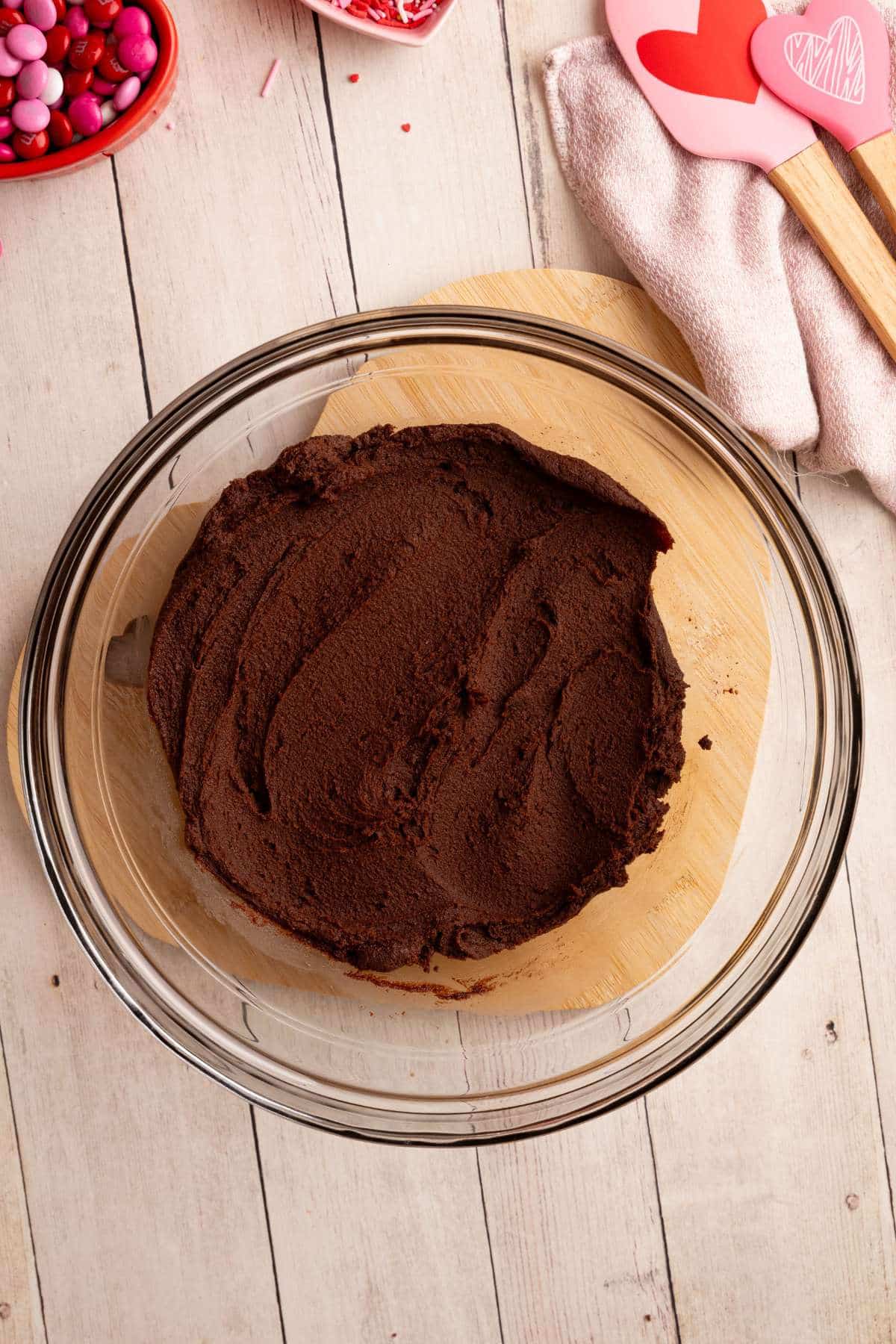 cookie dough fully mixed in a glass bowl.