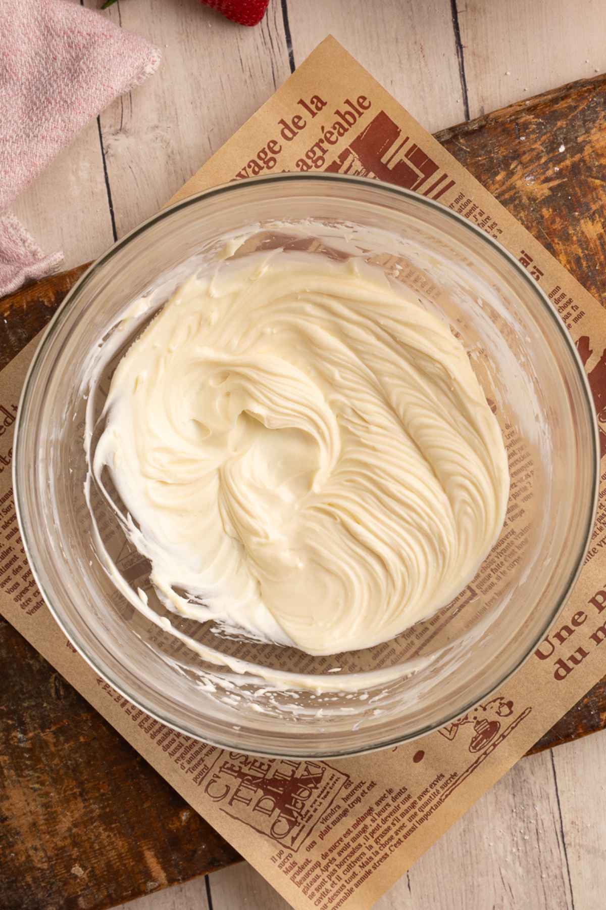 glass bowl with mixed vanilla cheesecake filling for deviled strawberries.