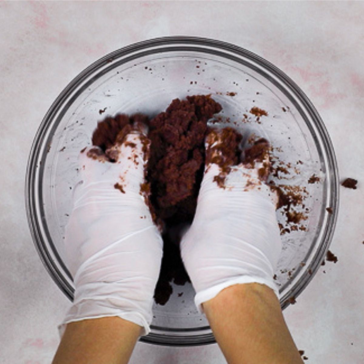 mixing cake and frosting in a glass bowl