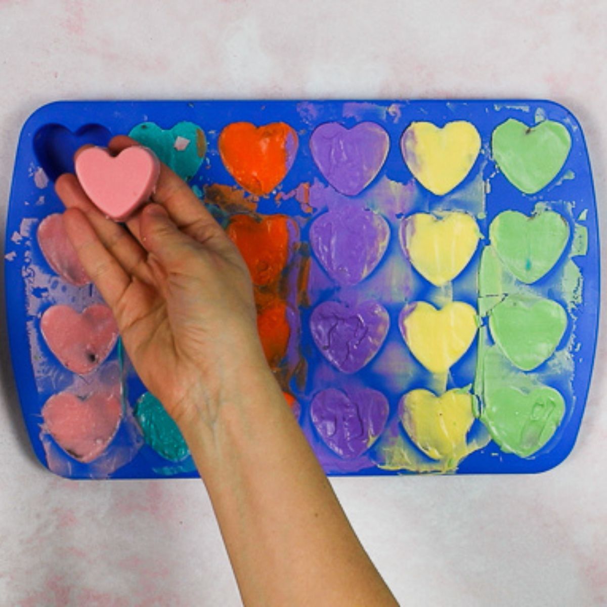 taking a pin valentine's day heart bite out of a silicone mold.