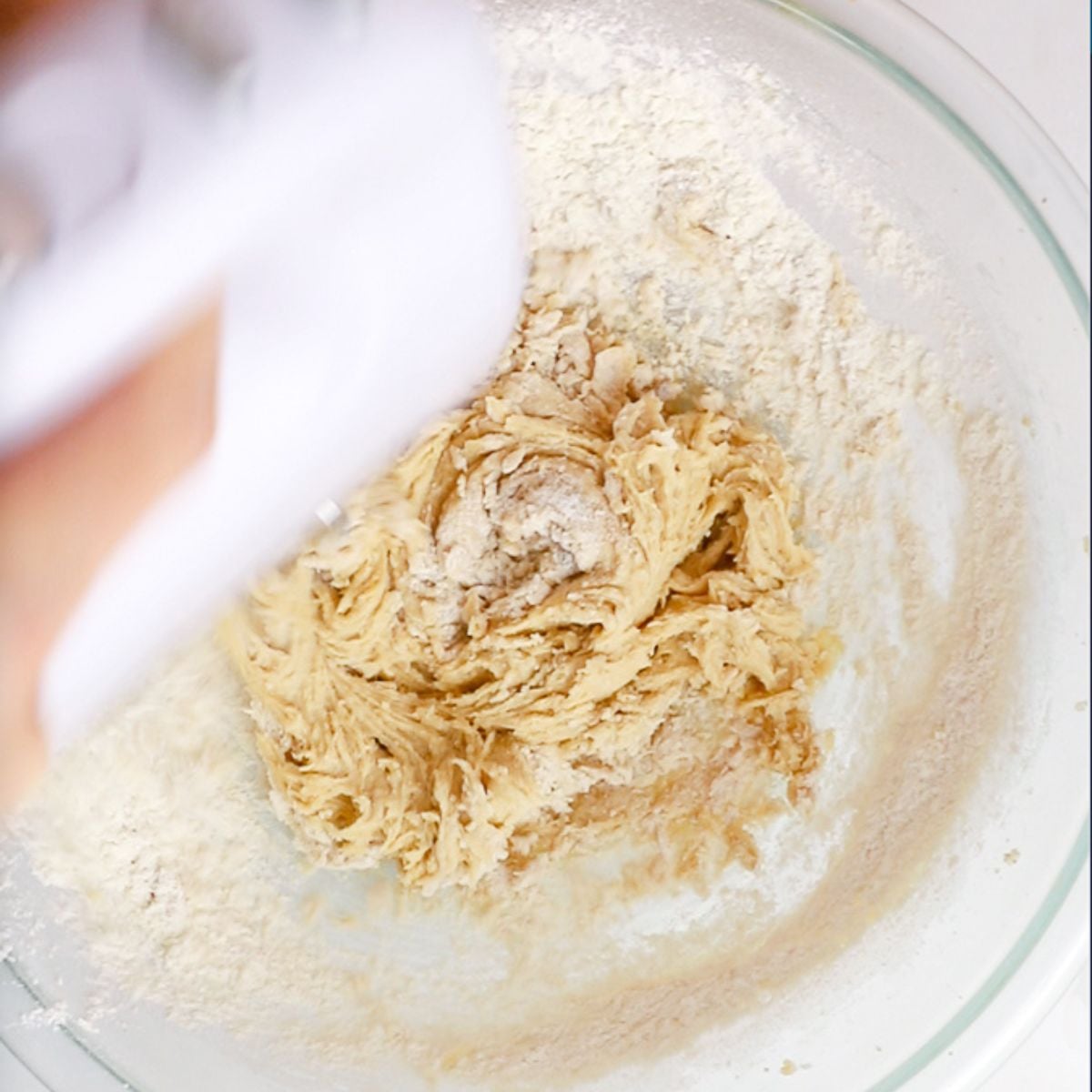 mixing in flour to cookie dough.