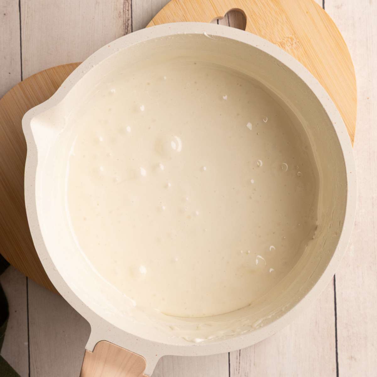 melted marshmallows in butter in a cream colored saucepan.