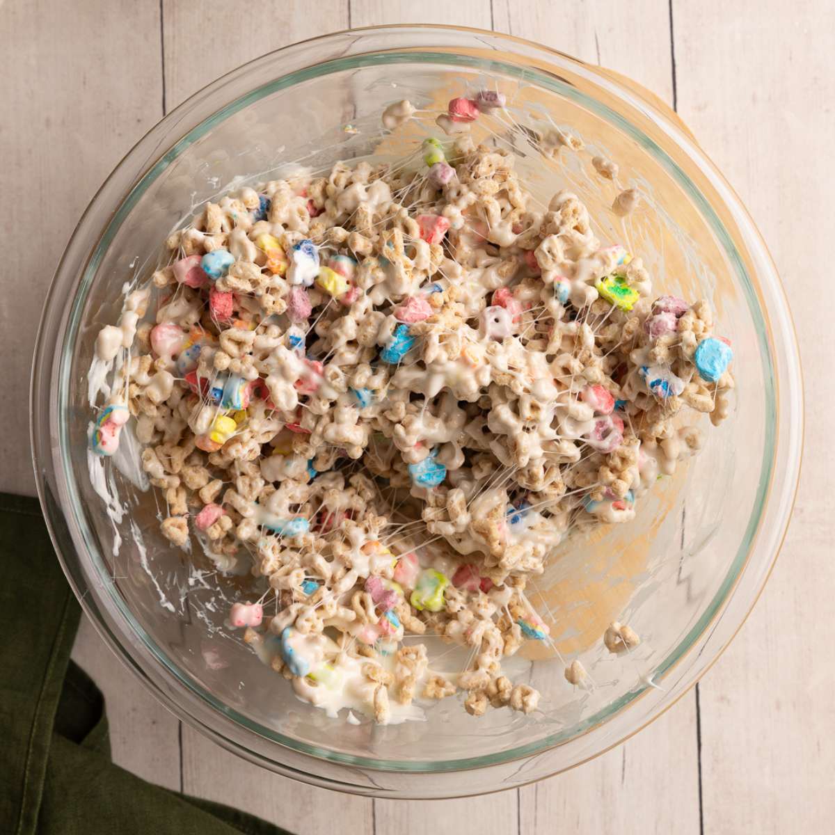 mixed lucky charms cereal and melted marshmallows in a glass bowl.